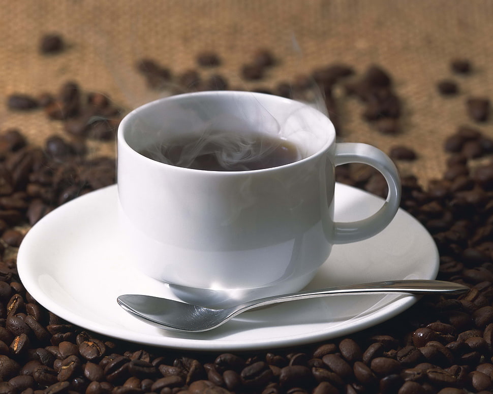 white ceramic teacup on saucer filled with black liquid HD wallpaper